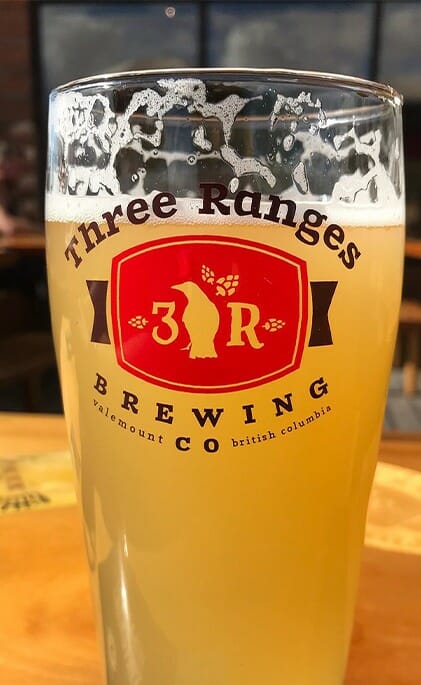 Three Ranges Brewing Valemmount CO British Columbia printed on a beer glass filled with beer