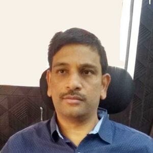 Suman - An Indian man wearing a blue shirt and black tie, looking confident and professional