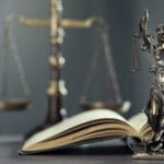 lady justice, open book and scales of justice